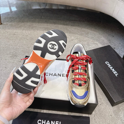 CHANEL 26S COLORBLOCK LOW TOP SNEAKERS IN GOLD CALFSKIN AND RED