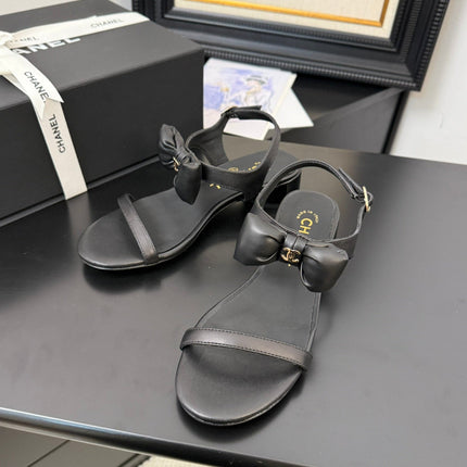 FLAT SANDALS IN BLACK CALFSKIN WITH BOW