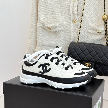 CHANEL 26S COLORBLOCK LOW TOP SNEAKERS IN WHITE CALFSKIN AND BLACK SUEDE