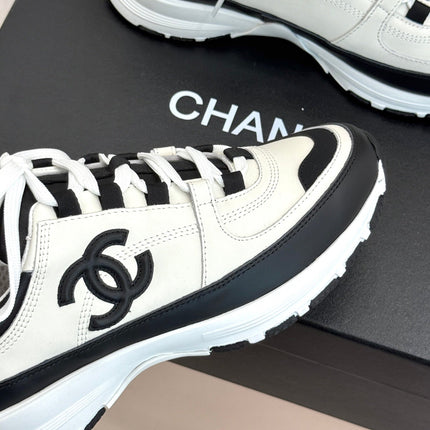 CHANEL 26S COLORBLOCK LOW TOP SNEAKERS IN WHITE CALFSKIN AND BLACK SUEDE