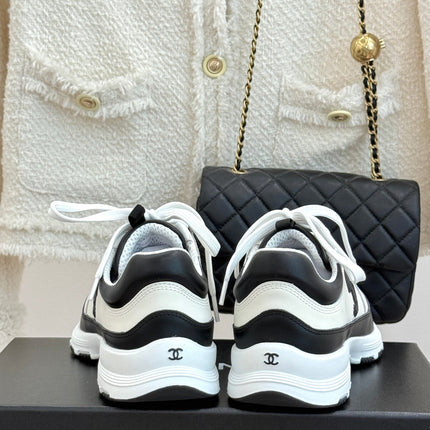 CHANEL 26S COLORBLOCK LOW TOP SNEAKERS IN WHITE CALFSKIN AND BLACK SUEDE
